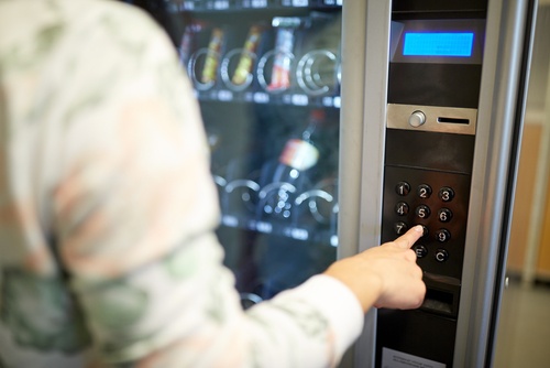 Person using vending machine at hotel in the lobby